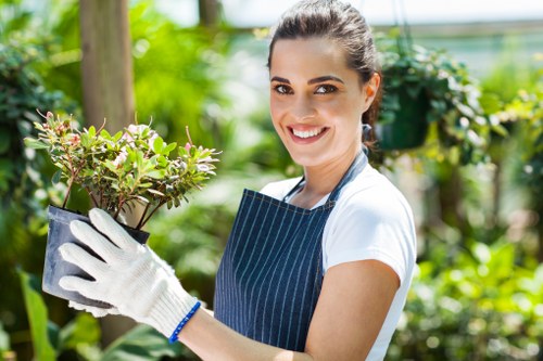 Team member trimming and edging a garden